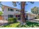 Two-story home features a red door, gray garage door, a black metal fence and a manicured lawn at 8464 N 7Th Ave, Phoenix, AZ 85021