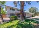 Two-story home features a red door, gray garage door, a black metal fence and a manicured lawn at 8464 N 7Th Ave, Phoenix, AZ 85021