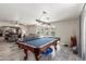 Open floor plan featuring a game room with pool table connected to a living room with comfortable seating at 8464 N 7Th Ave, Phoenix, AZ 85021