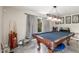 Spacious game room with a pool table, vintage arcade game, and natural light at 8464 N 7Th Ave, Phoenix, AZ 85021