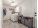 Spacious laundry room with sink, storage and gray tiled floor at 8464 N 7Th Ave, Phoenix, AZ 85021