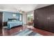 Bright main bedroom boasts hardwood floors, ceiling fan, and access to a balcony at 8464 N 7Th Ave, Phoenix, AZ 85021