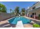 A sparkling pool with a slide and diving board alongside a two-story home with a covered patio at 8464 N 7Th Ave, Phoenix, AZ 85021