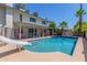 A pristine pool with a slide and diving board, complemented by the home and mature palm trees at 8464 N 7Th Ave, Phoenix, AZ 85021