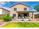 Spacious backyard with a green lawn, patio area, and well-kept landscaping, perfect for enjoying outdoor activities at 864 S 223Rd Ln, Buckeye, AZ 85326
