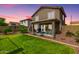 Lovely backyard with a vibrant green lawn and cozy patio area, ideal for relaxation and outdoor gatherings at 864 S 223Rd Ln, Buckeye, AZ 85326