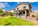 Well-maintained backyard featuring a lush green lawn, comfortable seating area, and attractive landscaping at 864 S 223Rd Ln, Buckeye, AZ 85326