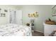 Light and airy bedroom with white accents, soft green walls, and minimalist decor at 864 S 223Rd Ln, Buckeye, AZ 85326