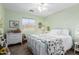 Bright bedroom with a metal frame bed, white dresser, and a sunlit window at 864 S 223Rd Ln, Buckeye, AZ 85326