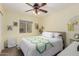 Cozy bedroom featuring a ceiling fan, a window, and a comfortable queen-size bed at 864 S 223Rd Ln, Buckeye, AZ 85326
