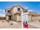 Well-maintained two-story home with desert landscaping and a for sale sign in the front yard at 864 S 223Rd Ln, Buckeye, AZ 85326