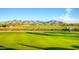 Scenic view of the golf course with mountain backdrop, highlighting the beautiful natural surroundings at 864 S 223Rd Ln, Buckeye, AZ 85326