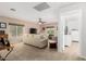 Bright living room featuring a ceiling fan, multiple windows, and neutral furniture at 864 S 223Rd Ln, Buckeye, AZ 85326