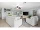 Open living space with comfortable seating, tile flooring, and views of the backyard through sliding glass doors at 864 S 223Rd Ln, Buckeye, AZ 85326