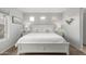 Serene main bedroom featuring a large bed, neutral decor, and ample natural light from multiple windows at 864 S 223Rd Ln, Buckeye, AZ 85326