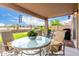 Relaxing covered patio area with outdoor seating, perfect for enjoying the views and entertaining guests at 864 S 223Rd Ln, Buckeye, AZ 85326