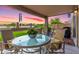 Inviting patio with comfortable seating area overlooking the beautifully landscaped backyard at sunset at 864 S 223Rd Ln, Buckeye, AZ 85326