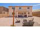 Spacious backyard featuring low maintenance landscaping, string lights, firepit and covered patio at 868 W Desert Glen Dr, San Tan Valley, AZ 85143