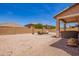 Expansive backyard features low maintenance landscaping, firepit, and covered patio at 868 W Desert Glen Dr, San Tan Valley, AZ 85143