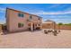 Large backyard features low maintenance landscaping, fire pit, covered patio and string lights at 868 W Desert Glen Dr, San Tan Valley, AZ 85143