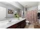 Neutral toned bathroom featuring a vanity, framed mirror and patterned shower curtain for a cozy feel at 868 W Desert Glen Dr, San Tan Valley, AZ 85143