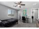 This bedroom includes a ceiling fan, a work space by the window and neutral toned paint at 868 W Desert Glen Dr, San Tan Valley, AZ 85143