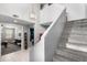 A two-story entryway showcasing carpeted stairs, modern lighting, and stylish decor at 868 W Desert Glen Dr, San Tan Valley, AZ 85143