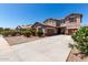 Charming two-story home with a well-manicured yard and a long driveway to two-car garage at 868 W Desert Glen Dr, San Tan Valley, AZ 85143