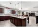 Kitchen with large center island, stainless appliances, and dark wood cabinetry at 868 W Desert Glen Dr, San Tan Valley, AZ 85143