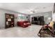 Open living room featuring tiled floor, modern ceiling fan, and a plush red leather couch at 868 W Desert Glen Dr, San Tan Valley, AZ 85143