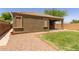 This low-maintenance backyard features desert landscaping, a small grass area and covered patio at 871 E Melanie St, San Tan Valley, AZ 85140
