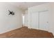 Bright bedroom with neutral walls, double door closet, and TV mount ready for your screen at 871 E Melanie St, San Tan Valley, AZ 85140
