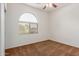 Inviting bedroom features a large arch window, plush carpet and ceiling fan at 871 E Melanie St, San Tan Valley, AZ 85140