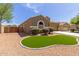 Attractive home with a well maintained artificial grass area and low maintenance desert landscaping at 871 E Melanie St, San Tan Valley, AZ 85140