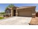 Charming home featuring desert landscaping, paver driveway, and a neutral color palette at 871 E Melanie St, San Tan Valley, AZ 85140