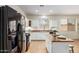 Well-lit kitchen with stainless steel appliances, white cabinetry, and island seating for relaxed dining and entertaining at 871 E Melanie St, San Tan Valley, AZ 85140
