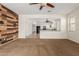 Open living room with modern wood wall and view into the kitchen, creating a spacious environment at 871 E Melanie St, San Tan Valley, AZ 85140
