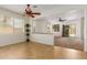 An open floorplan living room boasts tile and carpet flooring and seamless transition to the outdoor space at 871 E Melanie St, San Tan Valley, AZ 85140