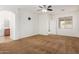 Spacious main bedroom featuring carpet, ceiling fan and ensuite bathroom at 871 E Melanie St, San Tan Valley, AZ 85140