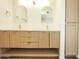 Bathroom featuring a double vanity with gold fixtures, white countertops, and neutral color palette at 925 E Wagoner Rd, Phoenix, AZ 85022