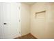 A well-lit bathroom featuring tiled walls, wooden look floors, and recessed wall storage at 925 E Wagoner Rd, Phoenix, AZ 85022