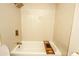 Bright bathroom featuring a shower/tub combo, tiled walls, and gold fixtures at 925 E Wagoner Rd, Phoenix, AZ 85022