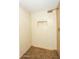 Bathroom featuring tiled walls, wooden look floors, and a shower with recessed wall storage at 925 E Wagoner Rd, Phoenix, AZ 85022