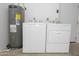 Garage laundry area with washer, dryer, and water heater at 925 E Wagoner Rd, Phoenix, AZ 85022