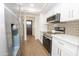 Modern kitchen featuring stainless steel appliances, white cabinets, and quartz countertops at 925 E Wagoner Rd, Phoenix, AZ 85022