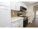 Bright kitchen featuring white cabinets, stainless steel appliances, and quartz countertops at 925 E Wagoner Rd, Phoenix, AZ 85022