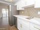 Well-lit kitchen showcasing stainless steel appliances, white cabinetry, and a contemporary design at 925 E Wagoner Rd, Phoenix, AZ 85022