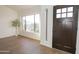 Bright living room offers wood-look tile flooring, modern front door, and plenty of natural light at 925 E Wagoner Rd, Phoenix, AZ 85022