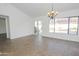 Inviting living room provides wood-look tile floors, a contemporary light fixture, and slider to backyard at 925 E Wagoner Rd, Phoenix, AZ 85022