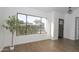 Inviting living room with wood-look tile floors, a large picture window, and neutral color palette at 925 E Wagoner Rd, Phoenix, AZ 85022